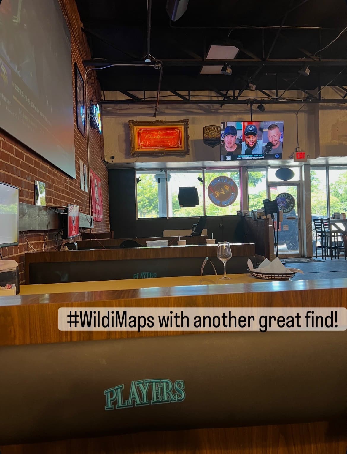 Players Locker Room bar interior with a drink on the counter and sports playing on the TVs.